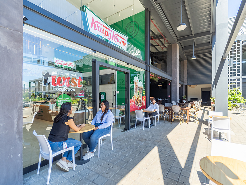 Krispy Kreme - Outdoor patio seating area with modern furniture and glass facade - Contract Workplaces.jpg